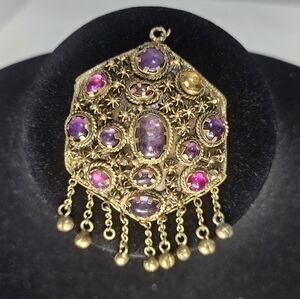 Vintage ornate pendant is a captivating piece of statement jewelry